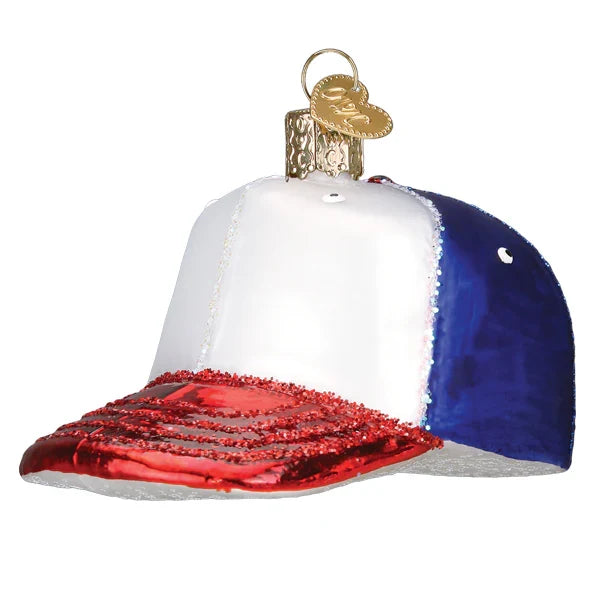 Decorative glass ornament shaped like a baseball cap with red, white, and blue colors on a white background.