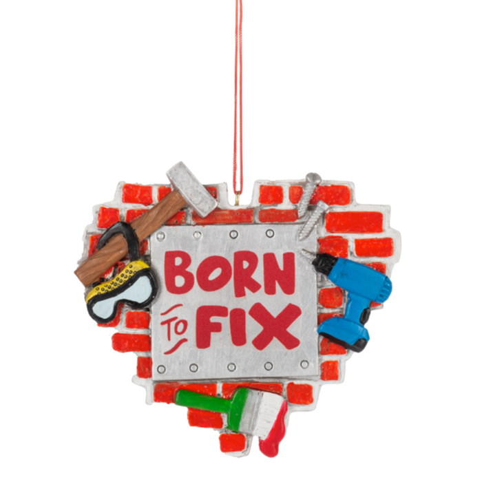 Personalized Born to Fix ornament shaped like a red brick wall with a silver sign, hammer, drill, paintbrush, screws, and safety goggles.