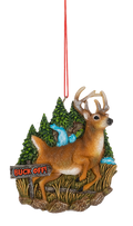 Buck Off Deer ornament featuring a standing brown buck with antlers in a woodland scene, complete with evergreen trees, a blue waterfall, tall grass, and a rustic “Buck Off!” sign.