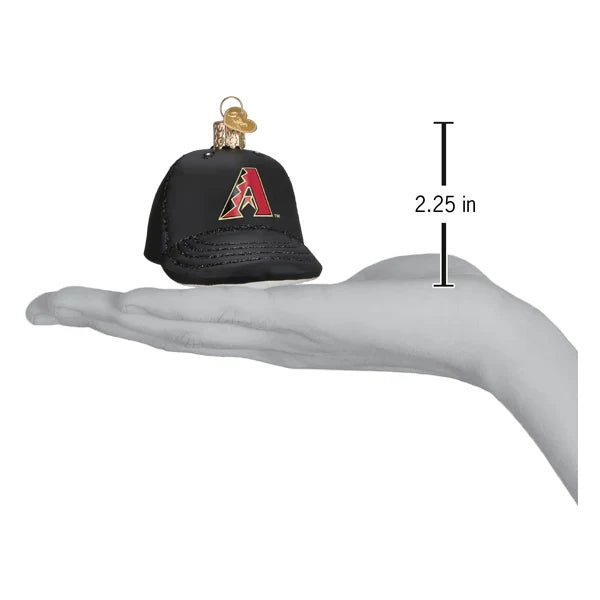 Black cap ornament with red logo on a hand, showing size measurement.