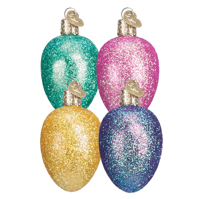 Four glittery Egg Shaped Christmas bulb ornaments in green, pink, gold, and blue on a white background.