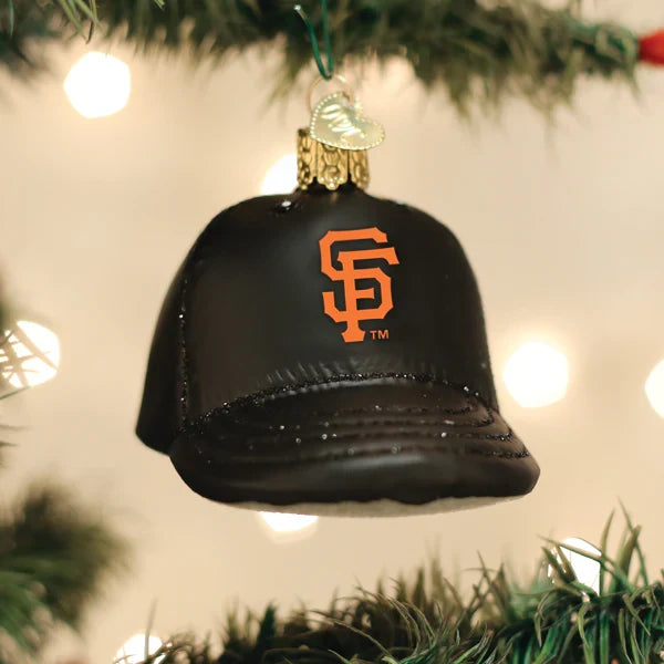 Black baseball cap ornament with Giants orange logo on a Christmas tree.