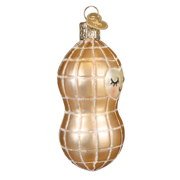 Decorative glass ornament shaped like a peanut with a smiling face on a white background side view