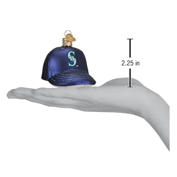 Glass ornament shaped like a baseball cap with a Mariners Logo and measurement indicator on a hand
