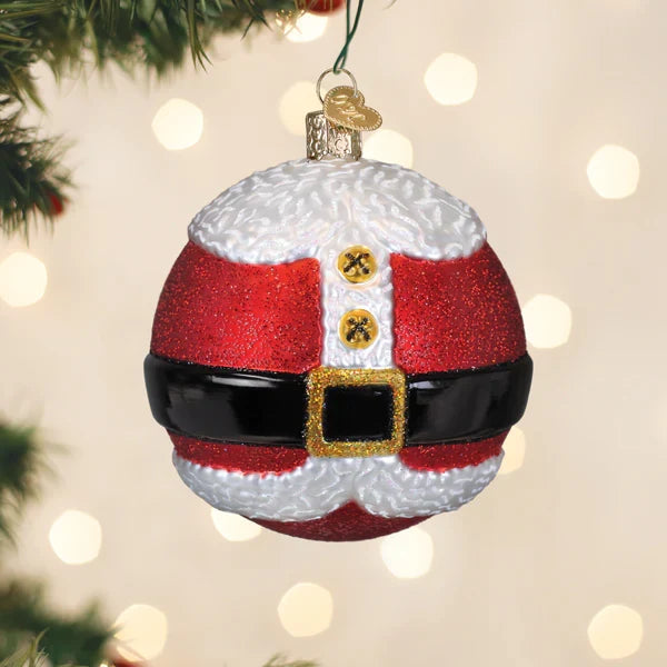 Decorative Christmas ornament shaped like a Santa Claus outfit on a blurred Christmas tree background.