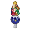 Nativity tree topper featuring Mary, Joseph, and Baby Jesus beneath a gold star on a blue ornament-style base with snowy white accents.