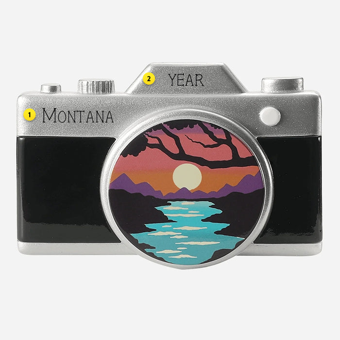 Camera-shaped ornament with a scenic design on a white background