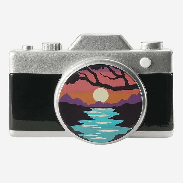 Camera-shaped ornament with a scenic design on the lens