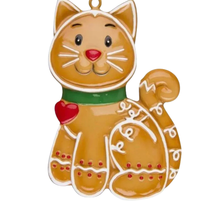 Gingerbread-style cat ornament with icing details, a green collar, curled tail, and small red heart on a plain background.