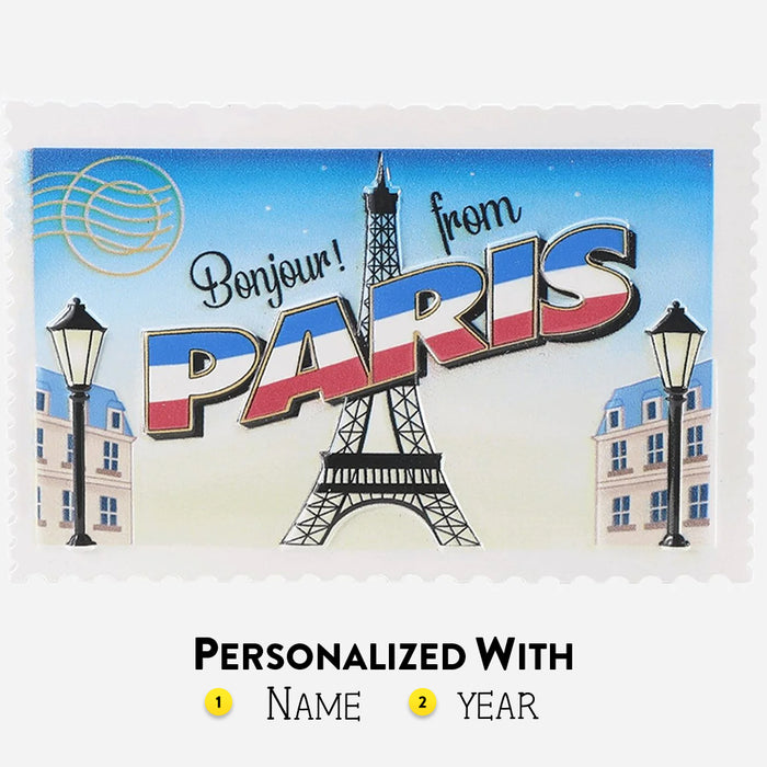 Postcard design ornament with Eiffel Tower and text 'Bonjour! from PARIS' on a blue sky background. Can be personalized