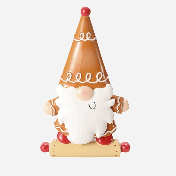 Gingerbread gnome ornament with a conical hat on a white background