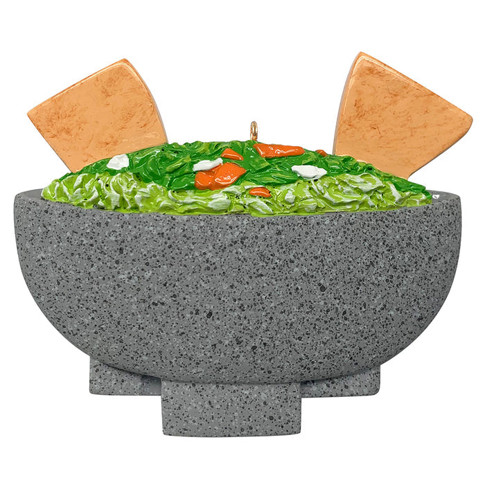 Decorative ornament shaped like a bowl of guacamole with tortilla chips on a white background