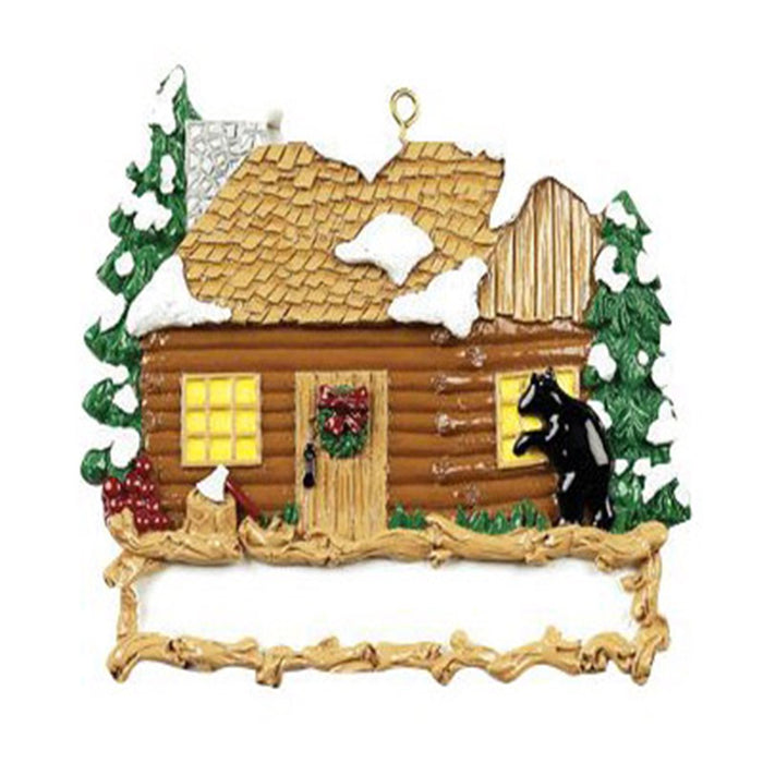 Decorative ornament of a log cabin with a bear and trees on a white background
