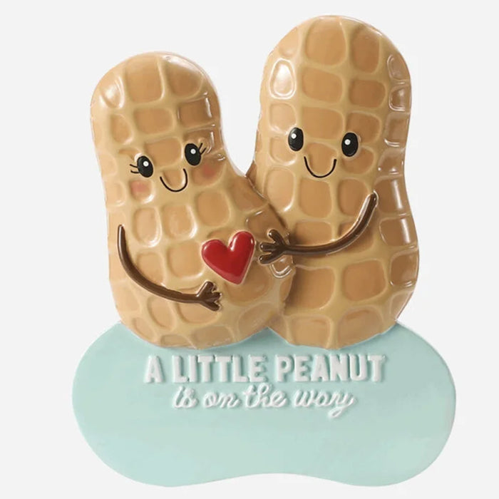 Decorative ornament with cartoon peanuts holding a heart, featuring text 'A Little Peanut is on the way' and  can be personalized.