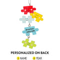 Colorful puzzle piece ornament with smiling faces on a white background