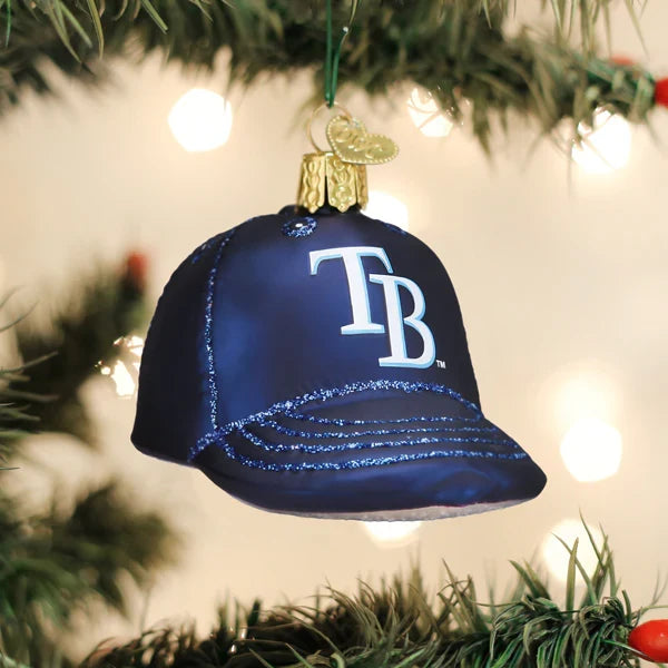 Navy blue baseball cap ornament with 'TB' logo on a Christmas tree.