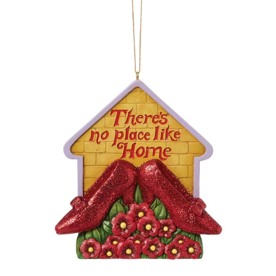 House-shaped ornament with glittery red slippers, red poppies, yellow brick background, and the phrase There’s No Place Like Home.