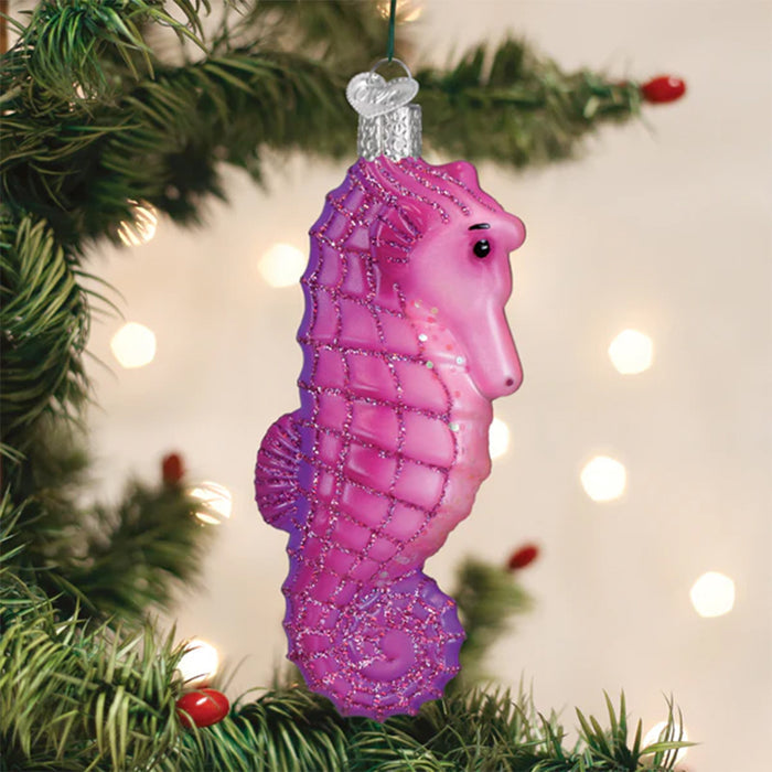 Purple seahorse ornament on a Christmas tree with lights in the background