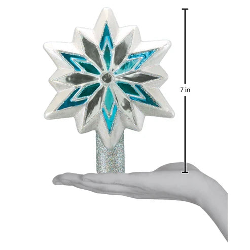 Snowflake Tree Topper shown standing on a hand for scale, measuring 7 inches tall.