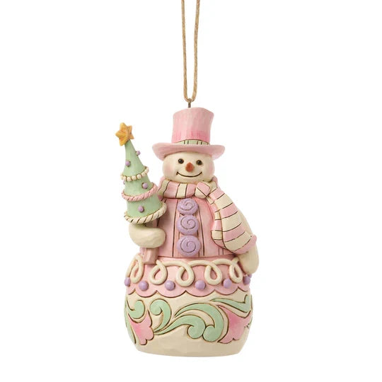Front view of Jim Shore Sweets Snowman with Tree Ornament featuring a smiling snowman in pastel pink holding a decorated Christmas tree.