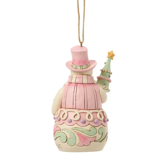 Back view of Jim Shore Sweets Snowman with Tree Ornament showing pink top hat, pastel scroll details, and tree held behind the snowman.