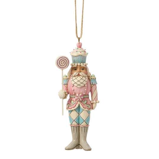 Front view of Jim Shore Sweets Soldier Lollipop Nutcracker Ornament featuring a pastel nutcracker with cupcake hat and swirled lollipop staff.